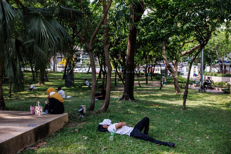 1255977151 A man sleeps at a park in Bangkok, Thailand, on Thursday, May 18, 2023. The emerging El Nino is already contributing to severe heat that's roasted Southeast Asia in recent weeks. The weather pattern typically results in hotter, drier conditions in many parts of Asia. Photographer: Andre Malerba/Bloomberg via Getty Images