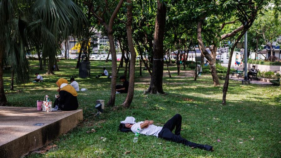 A man sleeps at a park in Bangkok, Thailand, on Thursday, May 18, 2023. The emerging El Nino is already contributing to severe heat that's roasted Southeast Asia in recent weeks. The weather pattern typically results in hotter, drier conditions in many parts of Asia. Photographer: Andre Malerba/Bloomberg via Getty Images