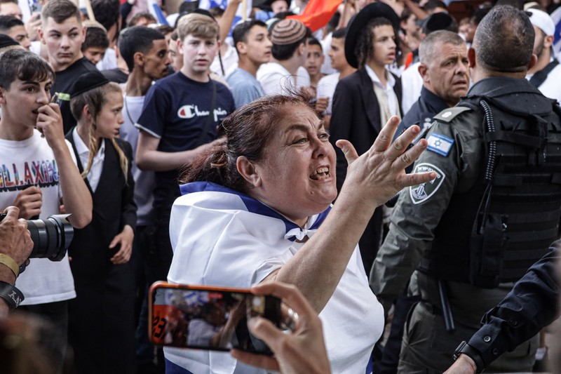 Yahudi Ultranasionalis Israel memegang bendera Israel saat mereka berbaris di kawasan Muslim kota tua Yerusalem pada 18 Mei 2023 di Yerusalem, Israel. Otoritas Israel akan mengizinkan orang-orang Yahudi Ortodoks berparade melalui Muslim Quarter Yerusalem dalam sebuah keputusan yang mengancam akan memicu kembali kekerasan di kota suci tersebut. (Amir Levy/Getty Images)