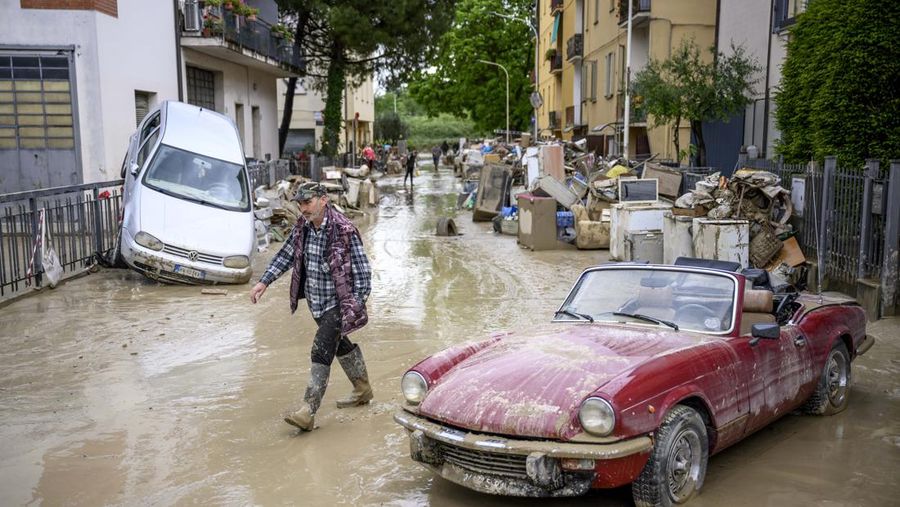 Warga membersihkan rumah mereka setelah hujan lebat menyebabkan banjir di wilayah Emilia Romagna utara Italia, pada 19 Mei 2023 di Faenza, Italia. Empat belas orang tewas dan ribuan orang telah dievakuasi dari rumah mereka setelah hujan deras menimbulkan kekacauan di wilayah Italia utara Emilia-Romagna, menyebabkan banjir dan tanah longsor yang parah. (Antonio Masiello/Getty Images)