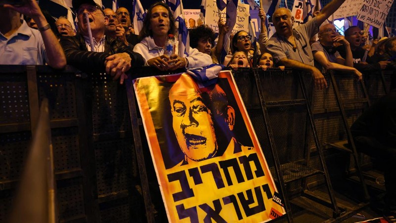 Demonstran mengibarkan bendera selama protes terhadap RUU perbaikan peradilan pemerintah Israel di Tel Aviv pada 20 Mei 2023. (AHMAD GHARABLI/AFP via Getty Images)