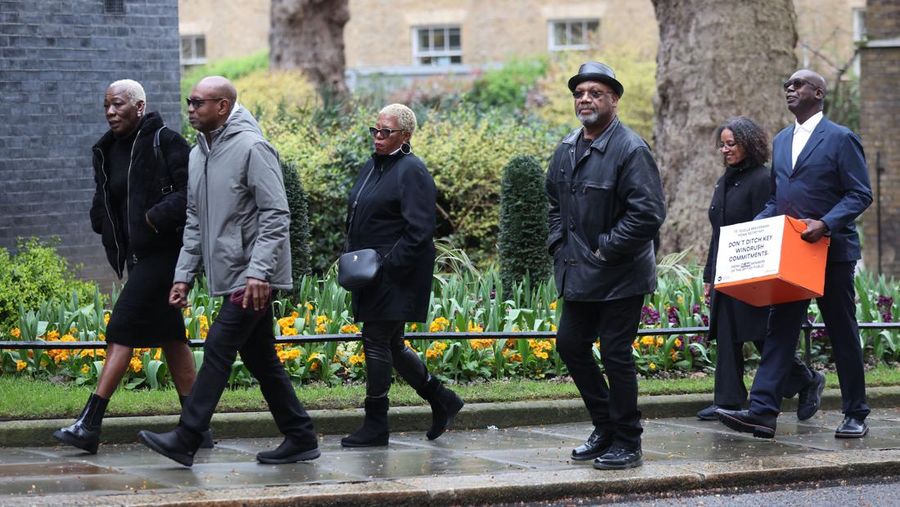 (L-R) Janet Mckay Williams, Michael Anthony Braithwaite, Glenda Caesar, Auckland Elwaldo Romeo, BEO chief executive Dr Wanda Wyporska and Patrick Vernon arrive to hand in a petition signed by Windrush survivors and celebrities at number 10 Downing Street in central London on April 6, 2023, calling for the government to adopt the recommendations of the independent inquiry into the Windrush scandal. - Britain's government Thursday faced legal action by campaigners over its refusal to accept key recommendations by an inquiry into the 