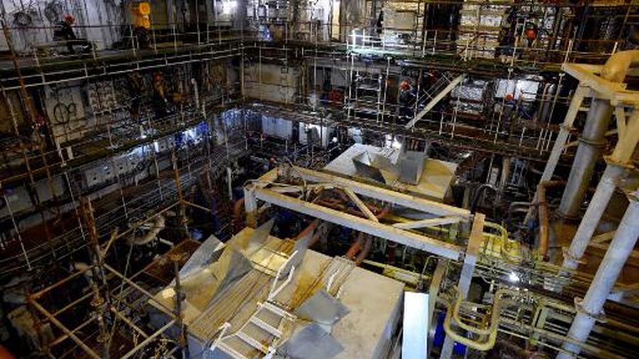 This photograph taken on July 5, 2021, shows a worker as they work in the engine hall of Russia's nuclear-powered icebreaker Sibir during construction at the Baltic Shipyard in Saint-Petersburg. At Saint Petersburg's historic Baltic Shipyard, cranes hover over the shining Neva River as hundreds of workers take part in the construction of four nuclear-powered ice-breakers.
Fronted by a Russian flag and named after the country's northern regions, the giant vessels are meant to ensure Moscow's dominance over the melting Arctic. (Photo by OLGA MALTSEVA / AFP)