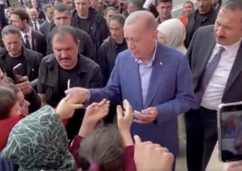 Presiden Turki Tayyip Erdogan membagikan uang kepada para pendukung yang berkumpul di luar TPS. Presiden Turki Tayyip Erdogan membagikan uang kepada para pendukung yang berkumpul di luar TPS. (REUTERS)