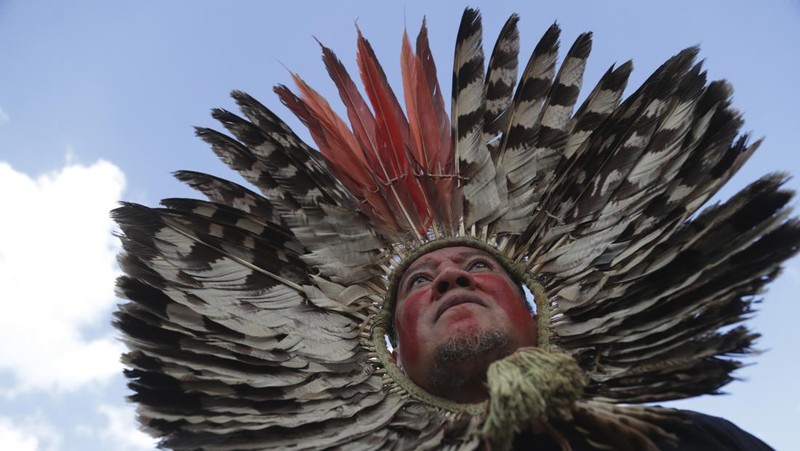 Guarani Indigenous block the Bandeirantes highway with burning tires to protest proposed legislation that would change the policy that demarcates Indigenous lands on the outskirts of Sao Paulo, Brazil, Tuesday, May 30, 2023. (AP Photo/Ettore Chiereguini)