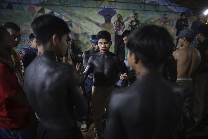 Guarani Indigenous block the Bandeirantes highway with burning tires to protest proposed legislation that would change the policy that demarcates Indigenous lands on the outskirts of Sao Paulo, Brazil, Tuesday, May 30, 2023. (AP Photo/Ettore Chiereguini)