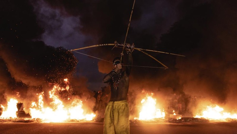 Guarani Indigenous block the Bandeirantes highway with burning tires to protest proposed legislation that would change the policy that demarcates Indigenous lands on the outskirts of Sao Paulo, Brazil, Tuesday, May 30, 2023. (AP Photo/Ettore Chiereguini)