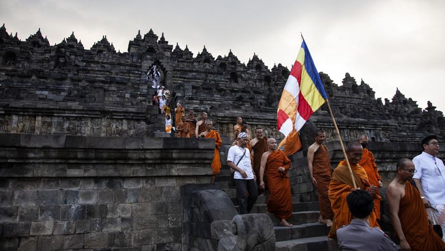 Buddhist monks descended from the Borobudur temple after performing Pradaksina at Borobudur temple in Magelang, Central Java, on June 1, 2023. 32 buddhist monks from Thailand, Malaysia and Indonesia who made a religious journey of more than 2,000 Km (International Thuddong), from Thailand to Indonesia, finished their journey at Borobudur Temple, to further celebrate Vesak Day on June 4. (Photo by Aditya Irawan/NurPhoto via Getty Images)