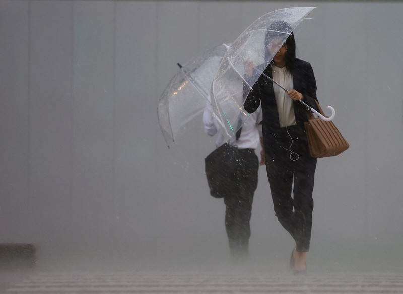 Pedestrians holding umbrellas make their way in the heavy rain in Tokyo, Japan, June 2, 2023. REUTERS/Kim Kyung-Hoon