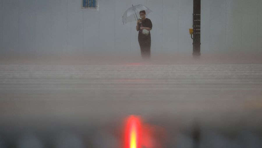 Pedestrians holding umbrellas make their way in the heavy rain in Tokyo, Japan, June 2, 2023. REUTERS/Kim Kyung-Hoon