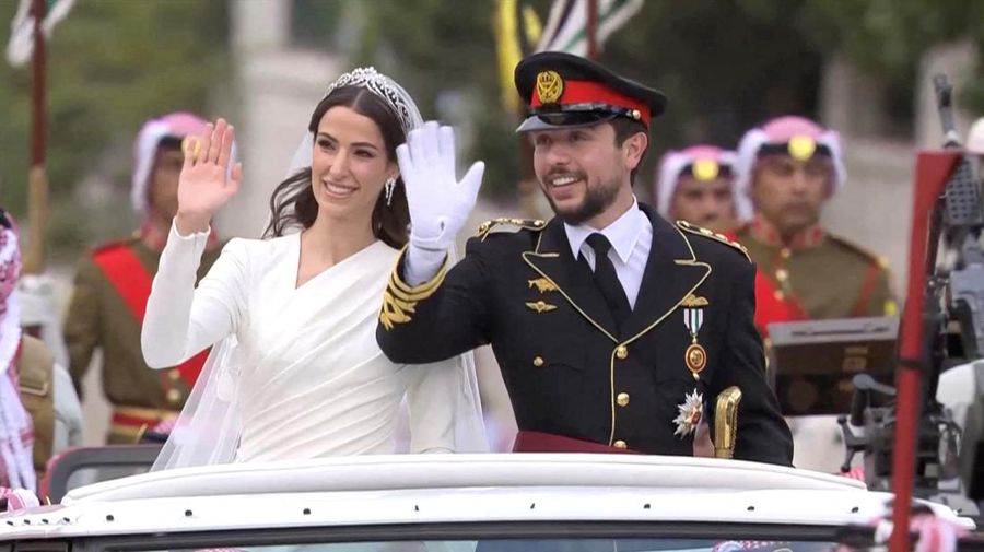 Jordan's Crown Prince Hussein and Rajwa Al Saif wave, after their royal wedding ceremony in Amman, Jordan, June 1, 2023 in this screen grab taken from a video. Royal Hashemite Court (RHC)/Handout via REUTERS ATTENTION EDITORS - THIS IMAGE WAS PROVIDED BY A THIRD PARTY. NO RESALES. NO ARCHIVES. REFILE - QUALITY REPEAT