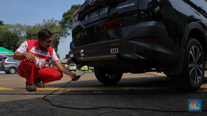 Petugas melakukan uji emisi kendaraan bermotor saat acara Uji Emisi Akbar (UEA) di Parkir Utara Taman Marga Satwa Ragunan, Jakarta, Senin (5/6/2023). (CNBC Indonesia/Faisal Rahman)