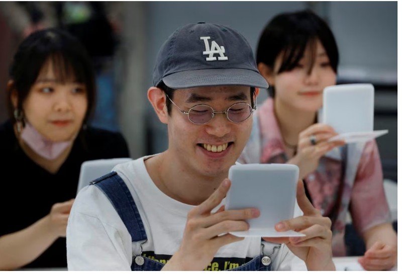 Students practice smiling at a smile training course at Sokei Art School in Tokyo, Japan, May 30, 2023. REUTERS/Kim Kyung-Hoon