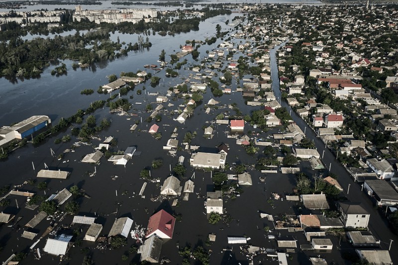 Russia Ukraine War Streets are flooded in Kherson, Ukraine, Wednesday, June 7, 2023 after the Kakhovka dam was blown up. Residents of southern Ukraine, some who spent the night on rooftops, braced for a second day of swelling floodwaters on Wednesday as authorities warned that a Dnieper River dam breach would continue to unleash pent-up waters from a giant reservoir. (AP Photo/Libkos)