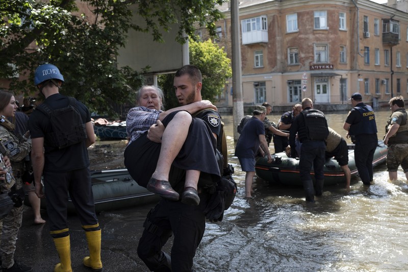 Streets are flooded in Kherson, Ukraine, Wednesday, June 7, 2023 after the Kakhovka dam was blown up. Residents of southern Ukraine, some who spent the night on rooftops, braced for a second day of swelling floodwaters on Wednesday as authorities warned that a Dnieper River dam breach would continue to unleash pent-up waters from a giant reservoir. (AP Photo/Libkos)