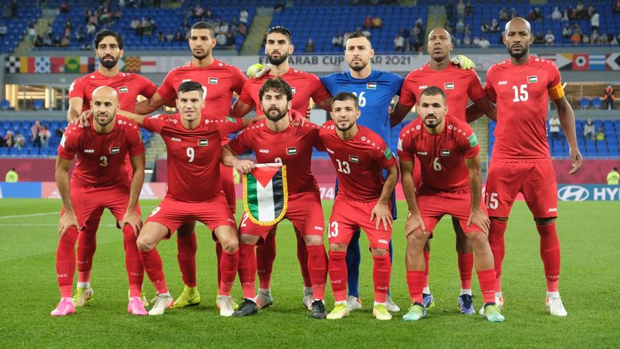 DOHA, QATAR - DECEMBER 07: Palestine national team starting eleven before the FIFA Arab Cup Qatar 2021 Group C match Jordan and Palestine at Stadium 974 on December 07, 2021 in Doha, Qatar. (Photo by Simon Holmes/Getty Images)