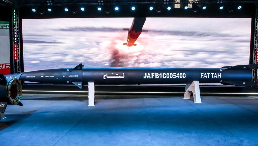 An Iranian couple walk past a giant image of Fattah, Iran's first-ever hypersonic missile, in Palestine square in downtown Tehran, June 7, 2023. According to Iran's state media, the Fattah solid fuel hypersonic missile can reach Tel Aviv in 400 seconds from inside Iran and travels at a speed of 5,145 meters per second.  (Photo by Morteza Nikoubazl/NurPhoto via Getty Images)