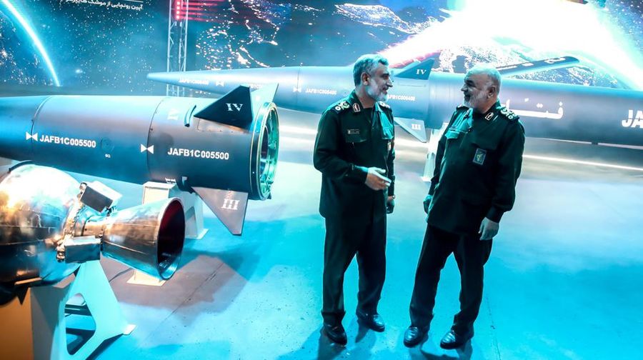 An Iranian couple walk past a giant image of Fattah, Iran's first-ever hypersonic missile, in Palestine square in downtown Tehran, June 7, 2023. According to Iran's state media, the Fattah solid fuel hypersonic missile can reach Tel Aviv in 400 seconds from inside Iran and travels at a speed of 5,145 meters per second.  (Photo by Morteza Nikoubazl/NurPhoto via Getty Images)