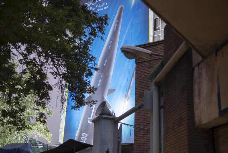 1258527747 An Iranian couple walk past a giant image of Fattah, Iran's first-ever hypersonic missile, in Palestine square in downtown Tehran, June 7, 2023. According to Iran's state media, the Fattah solid fuel hypersonic missile can reach Tel Aviv in 400 seconds from inside Iran and travels at a speed of 5,145 meters per second. (Photo by Morteza Nikoubazl/NurPhoto via Getty Images)