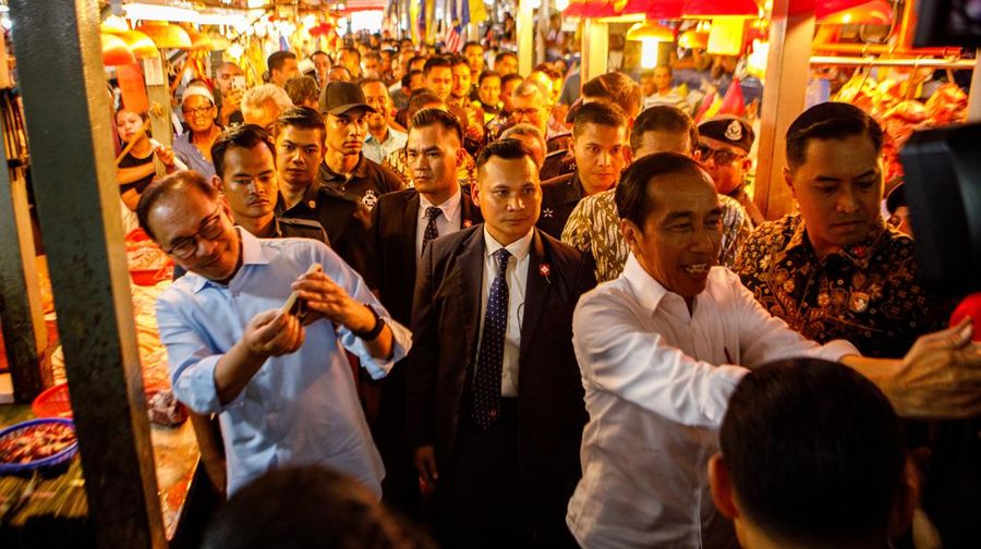 Joko Widodo, Indonesia's president, center, and Anwar Ibrahim, Malaysia's prime minister, center left, visit a wet market in Kuala Lumpur, Malaysia, on Thursday, June 8, 2023. Malaysia and Indonesia resolved the yearslong maritime border disputes and signed six agreements on trade, border controls and migrant worker problems during Widodo's two-day visit to Kuala Lumpur. Photographer: Samsul Said/Bloomberg via Getty Images