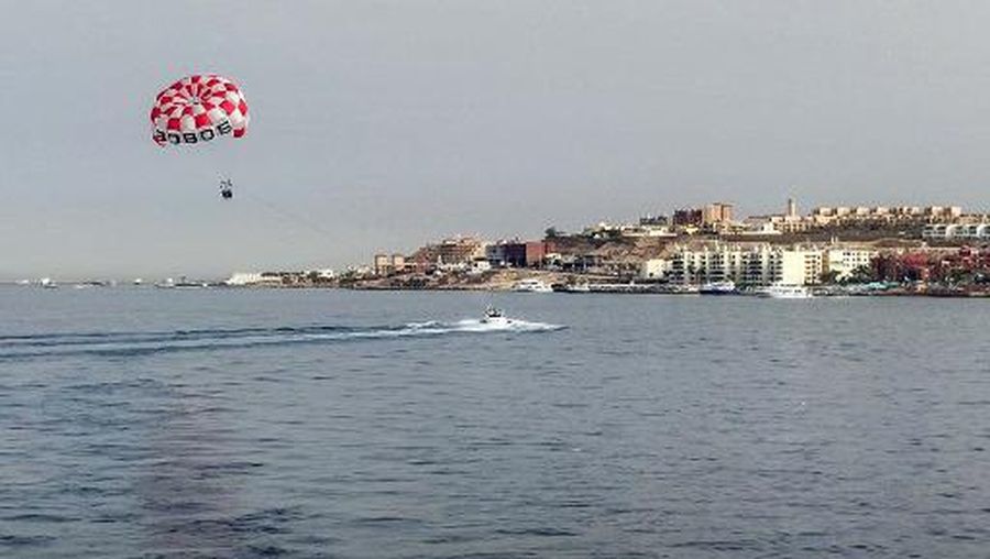 Tourists parasail in the Red Sea waters off of Egypt's southern resort city of Hurghada on June 8, 2023, where a Russian national was mauled by a shark. A Russian man was killed on June 8 after a shark attacked him off the coast of Egypt's Red Sea city of Hurghada, authorities said. Video footage said to be of the incident was widely circulated on social media in Egypt, showing a person struggling to escape from the shark. (Photo by AFP)