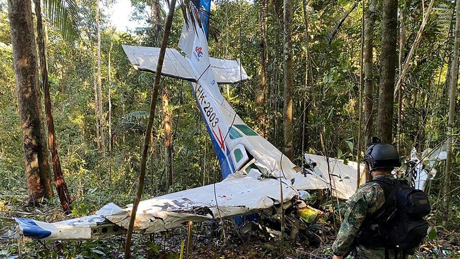 A soldier stands next to the wreckage of a plane during the search for child survivors from a Cessna 206 plane that crashed in the jungle more than two weeks ago in the jungles of Caqueta, Colombia May 19, 2023. Colombian Military Forces/Handout via REUTERS  ATTENTION EDITORS - THIS IMAGE WAS PROVIDED BY A THIRD PARTY. MANDATORY CREDIT. NO RESALES. NO ARCHIVES