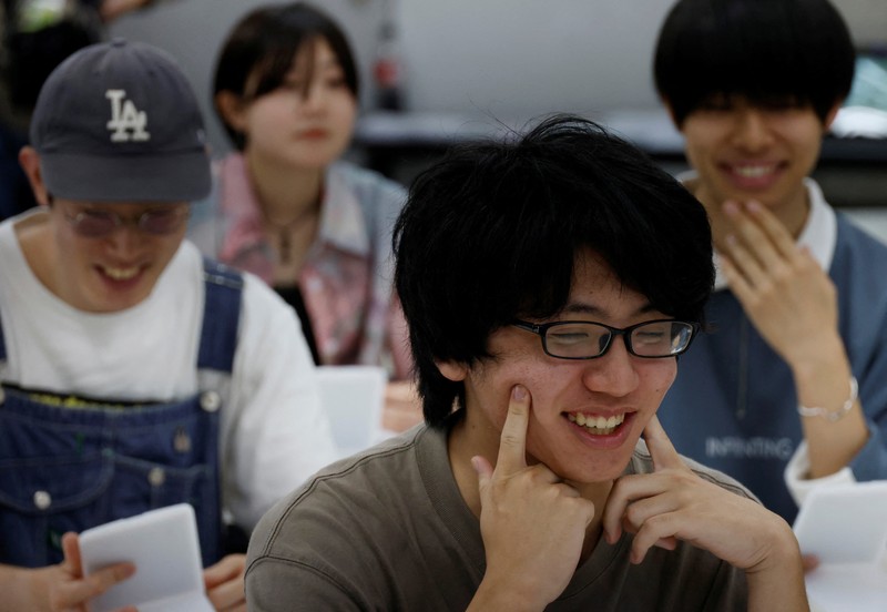 Students practice smiling at a smile training course at Sokei Art School in Tokyo, Japan, May 30, 2023. REUTERS/Kim Kyung-Hoon
