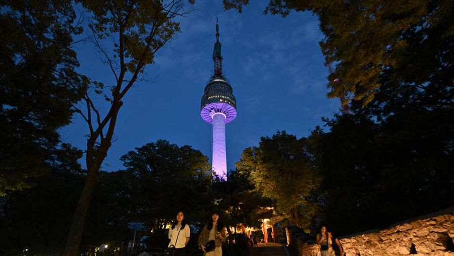 Menara Namsan Seoul yang terkenal diterangi dengan warna ungu untuk merayakan ulang tahun ke-10 debut megabintang K-pop BTS di Seoul pada 12 Juni 2023. (JUNG YEON-JE/AFP via Getty Images)