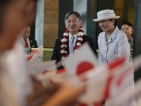 Japan's Emperor Naruhito, left, and Empress Masako talk to Japanese students who greet them upon arrival at their hotel in Jakarta, Indonesia, Saturday, June 17, 2023. The Japanese royals are on a weeklong visit in the country, their first official f