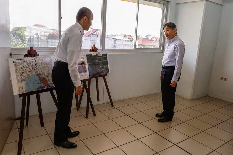 INDONESIA-JAPAN/EMPEROR Japan's Emperor Naruhito looks at a water pumping facility that was supported by the Japanese government as he is accompanied by Japan International Cooperation Agency (JICA) expert on integrated water resources management Kikuta Tomoya during a visit at Pluit water pump station in Jakarta, Indonesia, 18 June 2023. MAST IRHAM/Pool via REUTERS