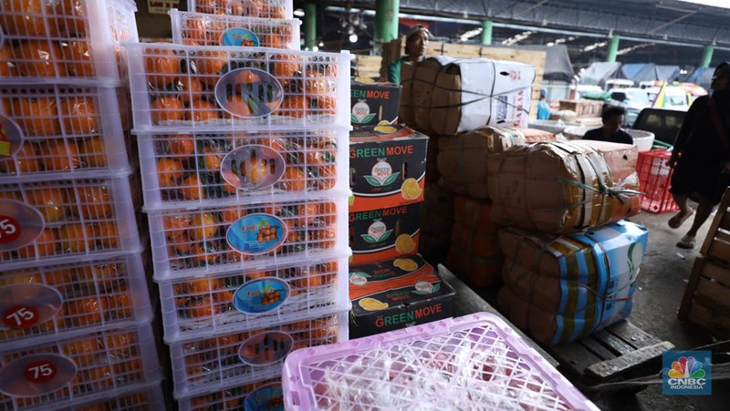 Pekerja melakukan bongkar muat buah impor dari China yang akan dipasarkan di Pasar Induk Kramat Jati, Jakarta, Senin (19/6/2023). (CNBC Indonesia/Tri Susilo)