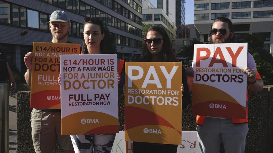 Junior doctors participate in a strike outside the St. Thomas' Hospital in London, Wednesday, June 14, 2023, at the start of a three day strike in an ongoing dispute over pay and conditions. (AP Photo/Kin Cheung)