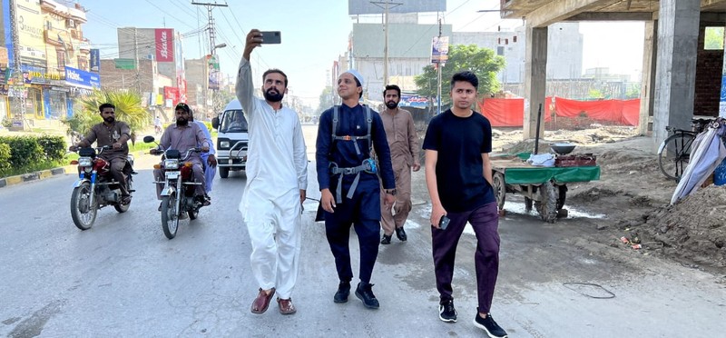 A Pakistani student, Usman Arshad, who walked 5400km from his home town, Okra, Pakistan to Mecca, Saudi Arabia to perform Haj, greets his family before heading out on his journey from Okra, Pakistan, in this handout photo obtained by Reuters on June 23, 2023. Usman Arshad/Handout via REUTERS ATTENTION EDITORS - THIS PICTURE WAS PROVIDED BY A THIRD PARTY