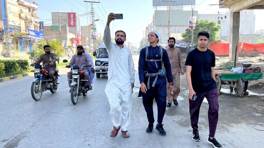 A Pakistani student, Usman Arshad, who walked 5400km from his home town, Okra, Pakistan to Mecca, Saudi Arabia to perform Haj, greets his family before heading out on his journey from Okra, Pakistan, in this handout photo obtained by Reuters on June 23, 2023. Usman Arshad/Handout via REUTERS ATTENTION EDITORS - THIS PICTURE WAS PROVIDED BY A THIRD PARTY