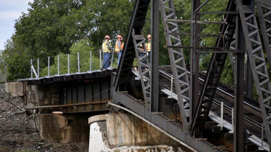Kereta api terguling di negara bagian Montana, Amerika Serikat (AS), dan menyebabkan jembatan di atas Sungai Yellowstone runtuh pada Sabtu pagi, (24/6/2023) waktu setempat. (AP/Larry Mayer)