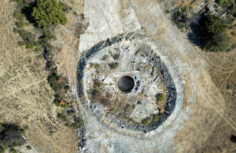 Smoke, believed to be methane gas, is seen at Virginia mine, a disused mine where a methane gas explosion killed at least 31 people last month, in Welkom, South Africa, June 26, 2023. REUTERS/Shafiek Tasiem
