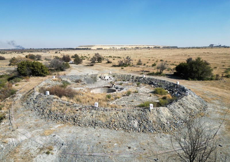 Smoke, believed to be methane gas, is seen at Virginia mine, a disused mine where a methane gas explosion killed at least 31 people last month, in Welkom, South Africa, June 26, 2023. REUTERS/Shafiek Tasiem