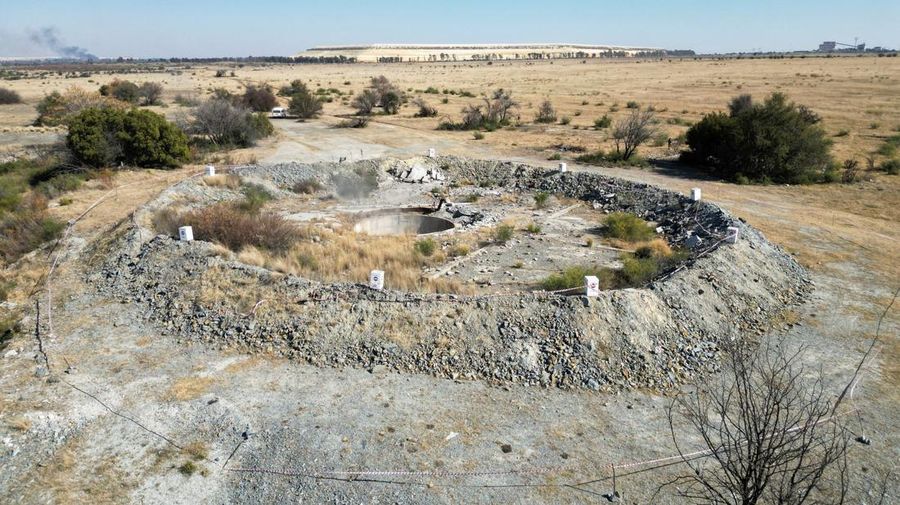 Smoke, believed to be methane gas, is seen at Virginia mine, a disused mine where a methane gas explosion killed at least 31 people last month, in Welkom, South Africa, June 26, 2023. REUTERS/Shafiek Tasiem
