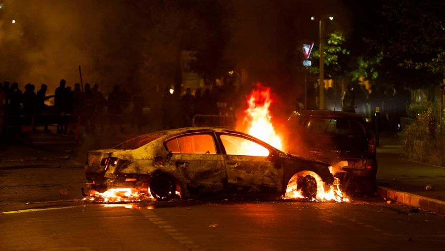 A vehicle burns during clashes between protesters and police, following the death of Nahel, a 17-year-old teenager killed by a French police officer during a traffic stop, in Nanterre, Paris suburb, France, June 29, 2023. REUTERS/Gonzalo Fuentes