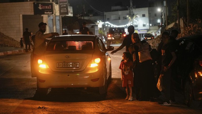 Warga Palestina yang tinggal di kamp pengungsian Jenin mulai meninggalkan rumah mereka, Senin malam (3/7/2023) waktu setempat. (AFP/JAAFAR ASHTIYEH)