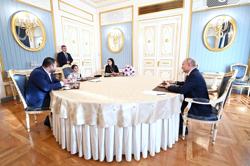 Raisat Akimova, seorang gadis berusia 8 tahun dari Derbent, dan orang tuanya Akhmet dan Kultum Aipovs menghadiri pertemuan dengan Presiden Rusia Vladimir Putin di Kremlin di Moskow, Rusia 4 Juli 2023. Raisat gagal menemui kepala negara selama kunjungannya perjalanan kerja ke Republik Dagestan di mana dia juga berbicara dengan penduduk setempat. (Sputnik/Alexander Kazakov/Kremlin via REUTERS)