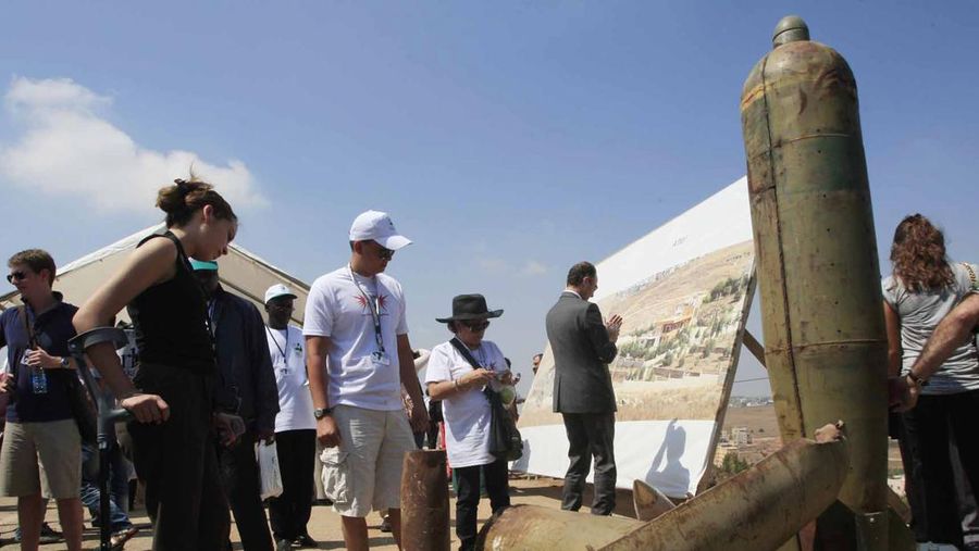 Activists and international delegations look at cluster bomb units, during a visit to a Lebanese military base at the opening of the Second Meeting of States Parties to the Convention on Cluster Munitions, in the southern town of Nabatiyeh, Lebanon, Monday Sept. 12, 2011. Lebanon is a country that has been severely impacted by cluster bombs over the course of several wars. (AP Photo/Mohammed Zaatari)