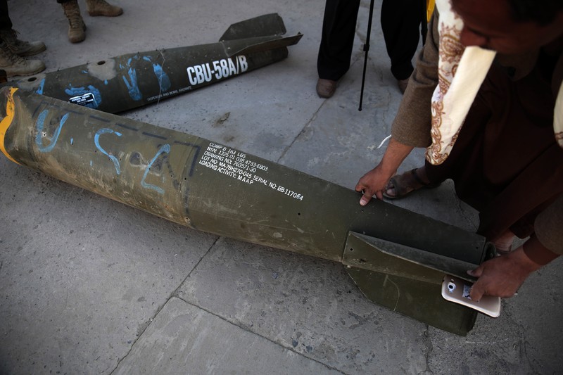 Mideast Yemen War Crimes Questions In this Oct. 5, 2016 photo, a Yemeni man displays an American-made CBU 58A/B, cluster bomb, in a police compound in Sanaa, Yemen. In the air campaign by Saudi Arabia and its allies against Yemen’s Shiite rebels, rights experts say there has been a pattern by the Saudi-led coalition in depending on faulty intelligence, failing to distinguish between civilian and military targets and disregarding the likelihood of civilian casualties. Experts say some of the strikes likely amount to war crimes. (AP Photo/Hani Mohammed)
