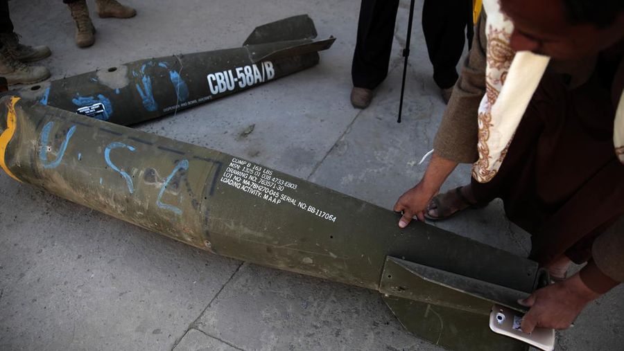 In this Oct. 5, 2016 photo, a Yemeni man displays an American-made CBU 58A/B, cluster bomb, in a police compound in Sanaa, Yemen. In the air campaign by Saudi Arabia and its allies against Yemen’s Shiite rebels, rights experts say there has been a pattern by the Saudi-led coalition in depending on faulty intelligence, failing to distinguish between civilian and military targets and disregarding the likelihood of civilian casualties. Experts say some of the strikes likely amount to war crimes. (AP Photo/Hani Mohammed)