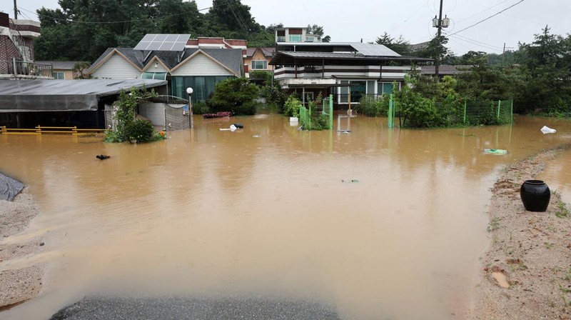 A view of a road submerged by a flooded river caused by heavy rain in Cheongju, South Korea, July 15, 2023.   Yonhap/via REUTERS       ATTENTION EDITORS - THIS IMAGE HAS BEEN SUPPLIED BY A THIRD PARTY. NO RESALES. NO ARCHIVE. SOUTH KOREA OUT. NO COMMERCIAL OR EDITORIAL SALES IN SOUTH KOREA. IMAGE BLURED AT SOURCE.