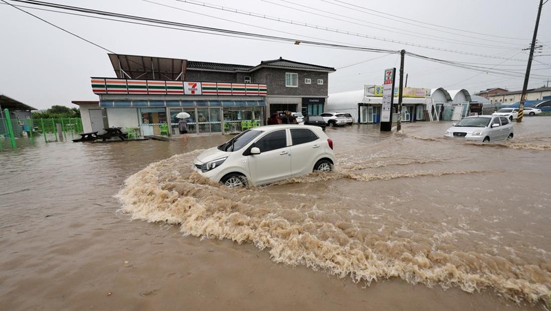 A view of a road submerged by a flooded river caused by heavy rain in Cheongju, South Korea, July 15, 2023.   Yonhap/via REUTERS       ATTENTION EDITORS - THIS IMAGE HAS BEEN SUPPLIED BY A THIRD PARTY. NO RESALES. NO ARCHIVE. SOUTH KOREA OUT. NO COMMERCIAL OR EDITORIAL SALES IN SOUTH KOREA. IMAGE BLURED AT SOURCE.