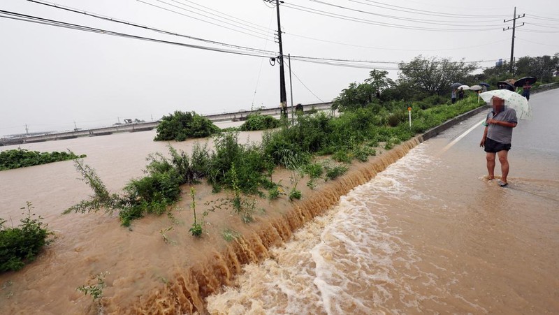 A view of a road submerged by a flooded river caused by heavy rain in Cheongju, South Korea, July 15, 2023.   Yonhap/via REUTERS       ATTENTION EDITORS - THIS IMAGE HAS BEEN SUPPLIED BY A THIRD PARTY. NO RESALES. NO ARCHIVE. SOUTH KOREA OUT. NO COMMERCIAL OR EDITORIAL SALES IN SOUTH KOREA. IMAGE BLURED AT SOURCE.