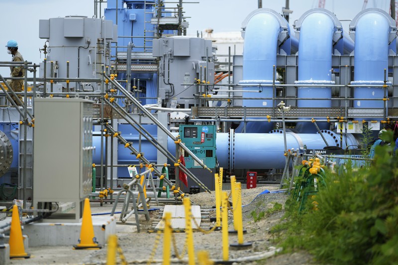 This photo taken during a tour for The Associated Press shows a blue pipeline to transport seawater, part of the facility for the release of treated radioactive water to sea from the Fukushima Daiichi nuclear power plant, operated by Tokyo Electric Power Company Holdings, also known as TEPCO, in Futaba town, northeastern Japan, Friday, July 14, 2023. (AP Photo/Hiro Komae)