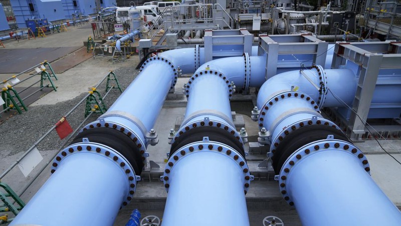 This photo taken during a tour for The Associated Press shows a blue pipeline to transport seawater, part of the facility for the release of treated radioactive water to sea from the Fukushima Daiichi nuclear power plant, operated by Tokyo Electric Power Company Holdings, also known as TEPCO, in Futaba town, northeastern Japan, Friday, July 14, 2023. (AP Photo/Hiro Komae)