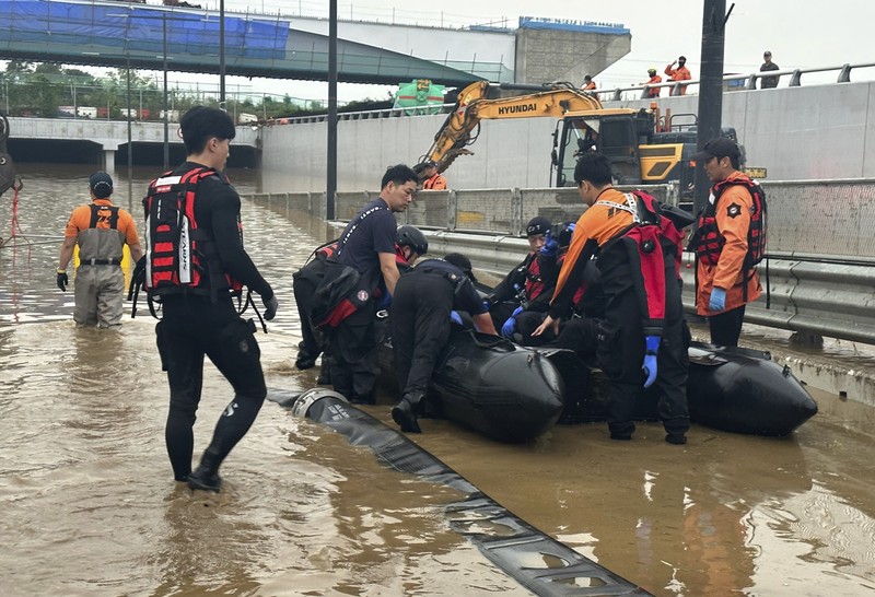 Tim penyelamat melakukan operasi pencarian di sepanjang jalan yang terendam banjir menuju terowongan bawah tanah di Cheongju, Korea Selatan, Minggu, 16 Juli 2023. Tim penyelamat melakukan operasi pencarian di sepanjang jalan yang terendam banjir menuju terowongan bawah tanah di Cheongju, Korea Selatan, Minggu, 16 Juli 2023. Hujan deras berhari-hari memicu banjir bandang dan tanah longsor serta menghancurkan rumah, menyebabkan puluhan orang tewas dan memaksa ribuan orang untuk mengungsi, kata para pejabat, Minggu. (Kim Ju-hyung/Yonhap via AP)